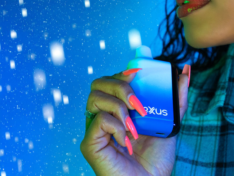 Woman holding the Exxus Snap DLX Voltage Battery outside with snow falling